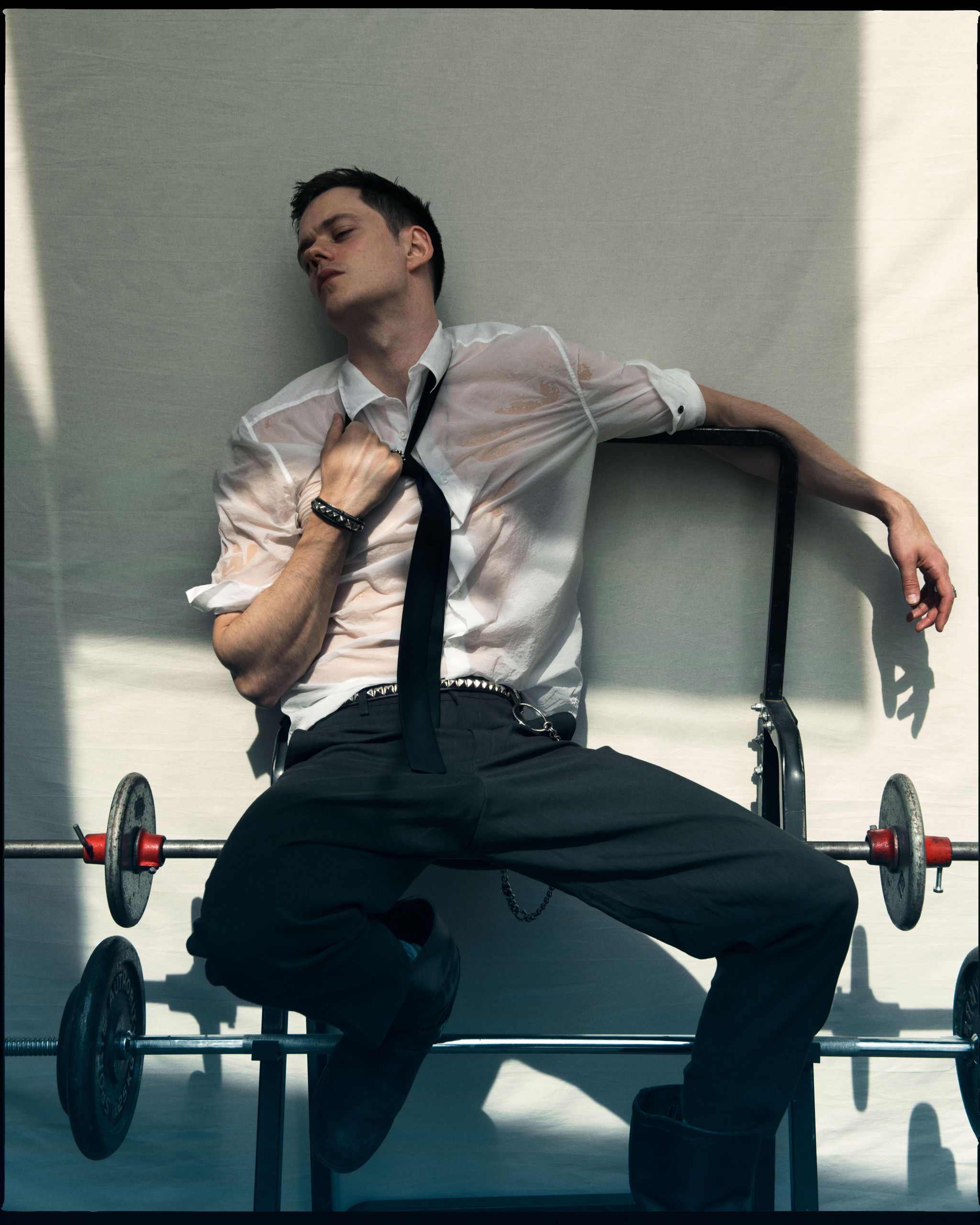a man in a tie sitting in a wheelchair