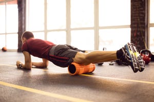 Exercising with foam roller in the gym