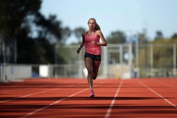 hiit training, high intensity interval training, a female athlete runs on a track