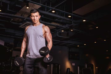 fit chinese man with dumbells