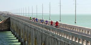 a group of people on a bridge in the florida keys