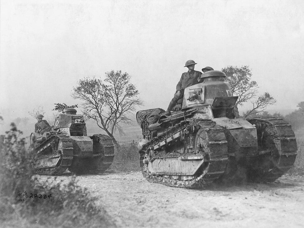 world war i photo of american troops advancing with ft 17 light tank
