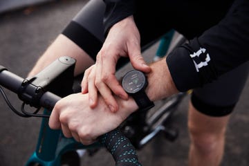 a cyclist starts a garmin watch before a ride