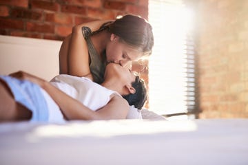 cropped shot of an affectionate young lesbian couple lying in bed