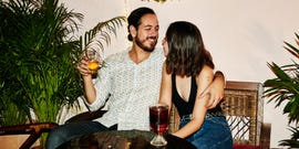 smiling couple embracing during date at night club