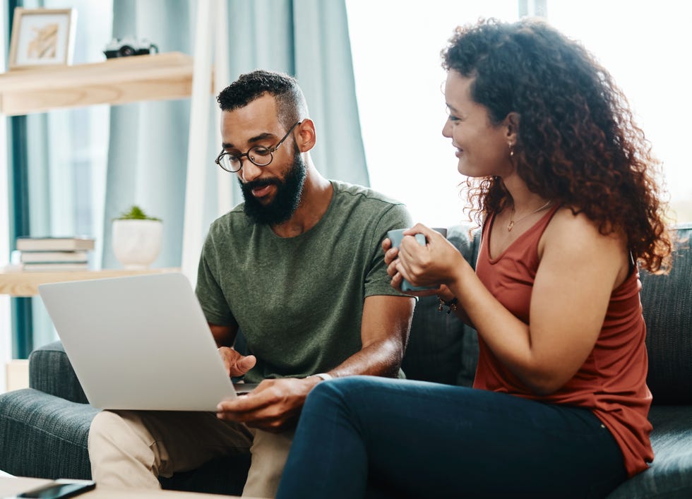 shot of a young couple going over their finances together at home