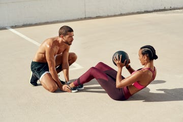 shot of a young woman working out with her personal trainer