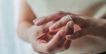 a close up view of a young woman wearing her wedding ring