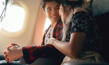 young asian couple holding hands, excied about their date trip