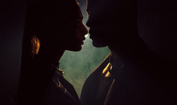 sensuous young woman close to kiss man against light background silhouette of man and woman closing to kiss shadow of two lovers forbidden love close to kiss passionate couple intimacy