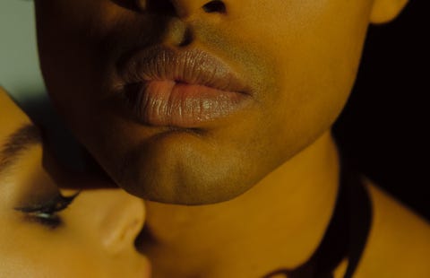 sensitive portrait of mixed race couple man wearing leather collar, woman touch him close up of sexy couple passionate portrait of man and woman