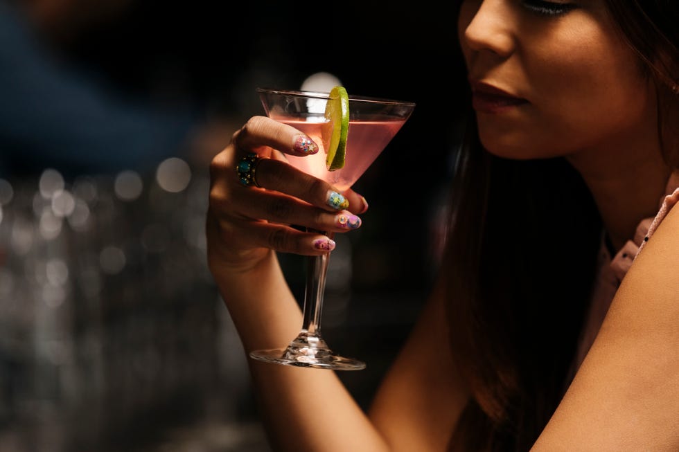 a woman holding a glass of wine