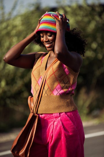 copenhagen, denmark   august 12 guest wearing pink pants, brown and pink knitted top and colorful rainbow hat outside ganni during copenhagen fashion week ss22 on august 12, 2021 in copenhagen, denmark photo by raimonda kulikauskienegetty images