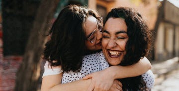 a woman kissing a man on the cheek