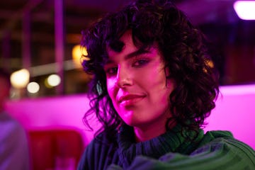 portrait of young woman at illuminated bowling alley