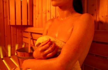 girl in sauna,, sweating,, visible water drops sweat