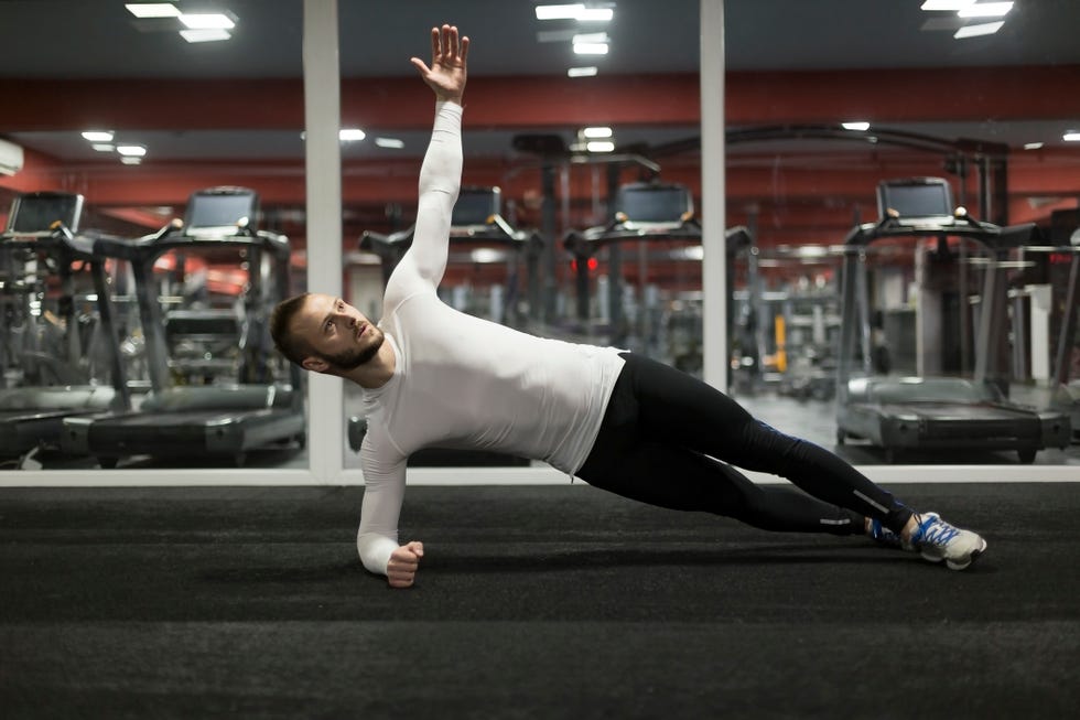 fitness man doing plank exercise in gym