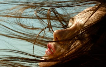 caucasian woman with hair blowing in wind