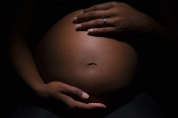 a person holding a baby's stomach