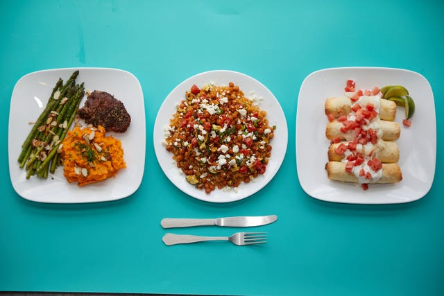 prepared dishes on a blue background for good housekeeping best meal delivery services testing