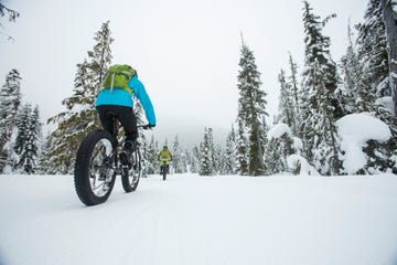 group of friends riding their fat bike in the snow in whistler, canada