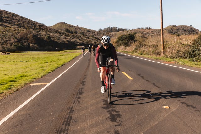 group of happy cyclists riding on the road