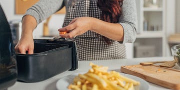 woman cooking with air fryer