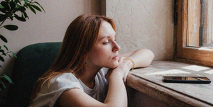 young women looks stressed staring at her phone