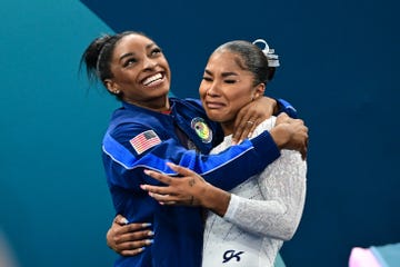 simone biles and jordan chiles hug after jordan chiles wins bronze in the floor final in the 2024 paris olympics