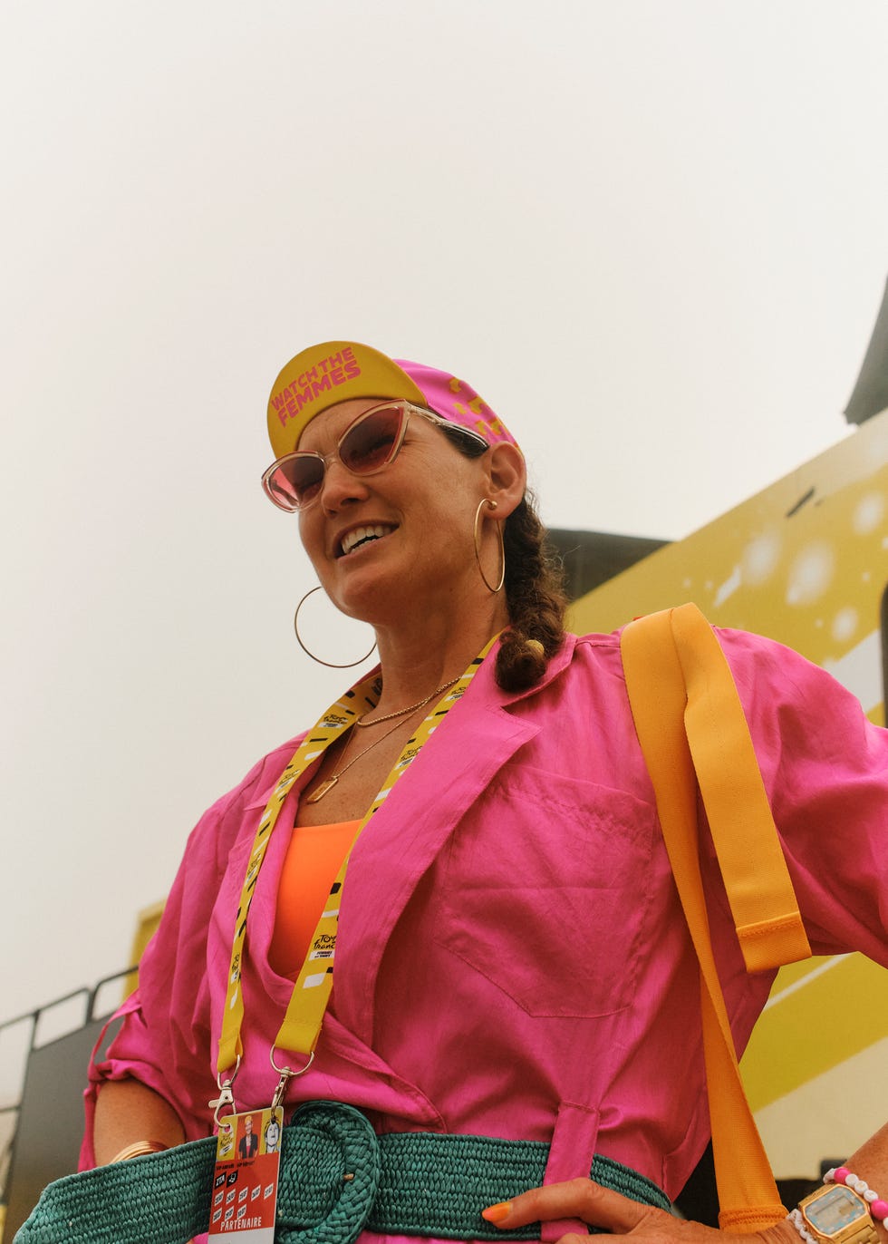 a woman wearing a pink shirt, sunglasses, and a hat that says watch the femmes