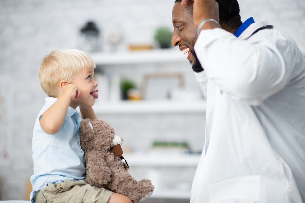 kid making silly faces with his doctor