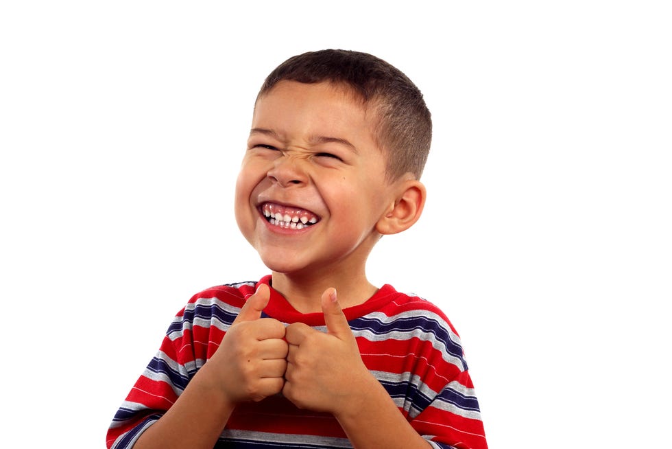 smiling kid giving two thumbs up