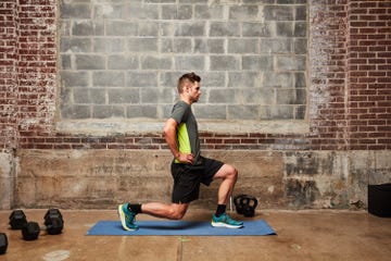 a man doing a squat on a mat