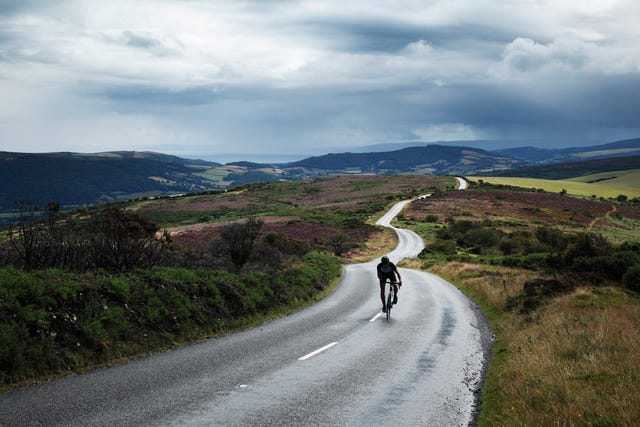 lone cyclist on winding road