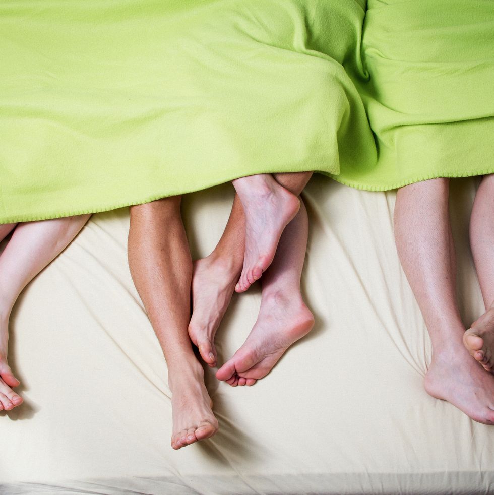 Low Section Of People In Bed
