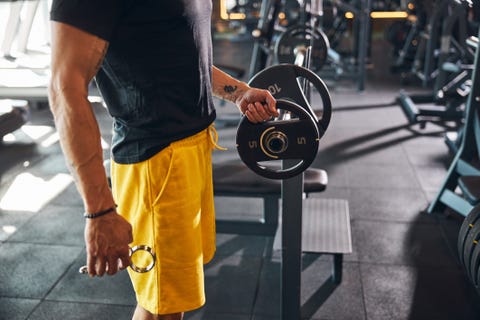 male athlete loading the barbell before the workout