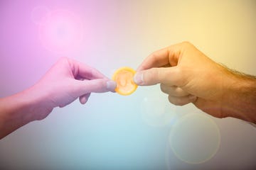 man and woman's holding condom