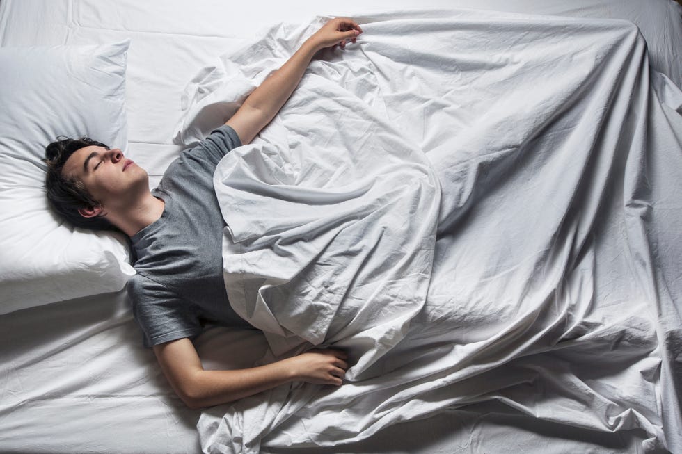 Man asleep in a bed