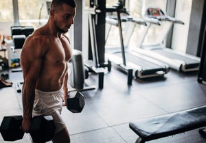 man carrying dumbbells