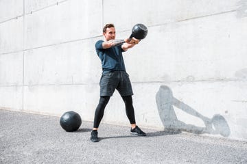 Man exercising with a kettlebell outdoors