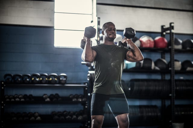 daily undulating periodization   man lifting dumbells at cross training gym