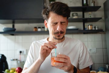 man making the face after he tasted the juice