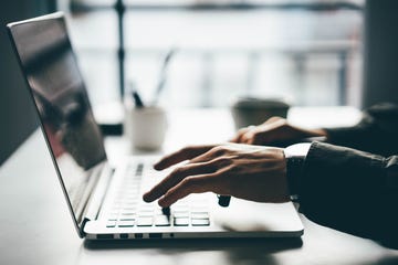 man working online at home on his laptop computer