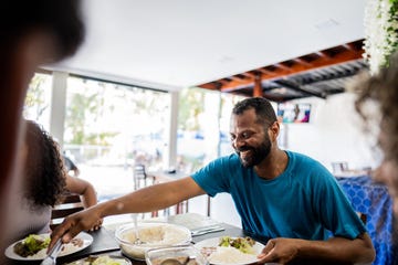 mature man having lunch with family at hotel restaurant