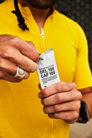 cyclist holding a maurten carbohydrate gel