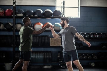 men fist bumping after cross training class