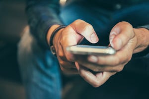 Midsection Of Man Using Mobile Phone