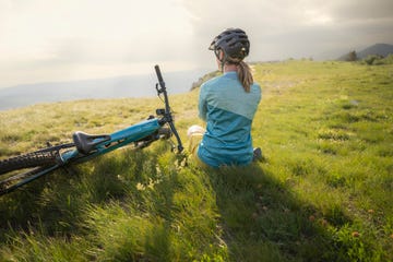 mountain biker sitting on mountain top