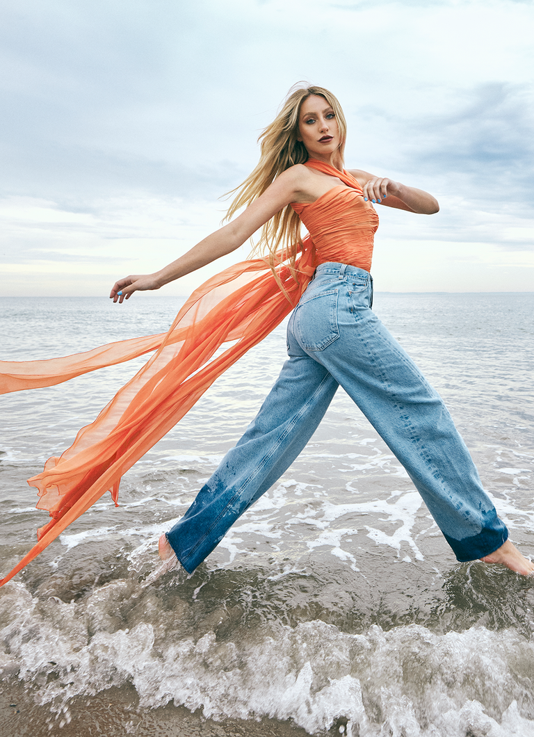 a person in a blue dress on a beach