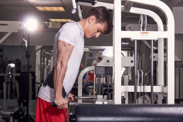 one young man, 20 years old, side view, gym indoors, dip exercise, dipping stand station